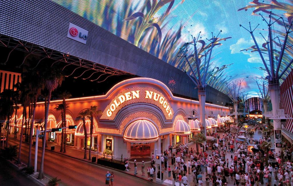 a large crowd of people standing in front of a large building at Golden Nugget Hotel & Casino Las Vegas in Las Vegas