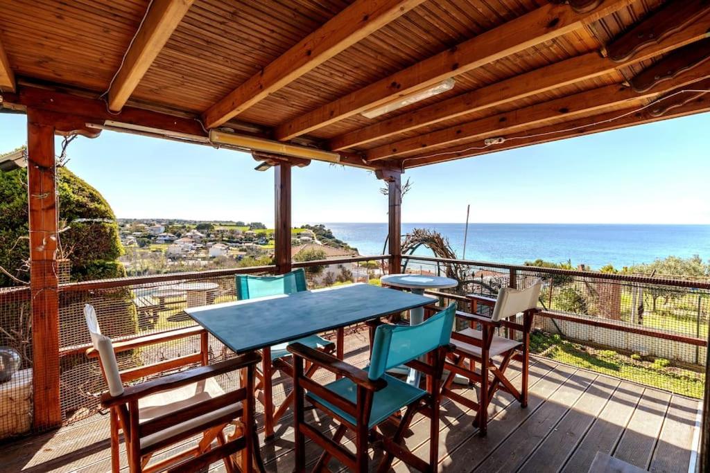 stół i krzesła na tarasie z widokiem na ocean w obiekcie KariBa House - Sunset view w mieście Nea Potidaea