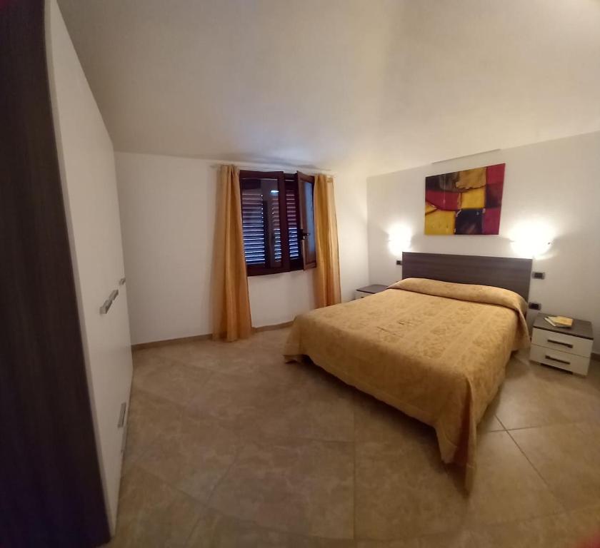 a bedroom with a large bed and a window at Casa Panoramica in Orosei