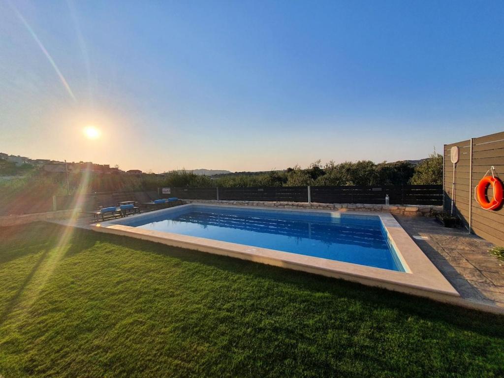 a swimming pool in the yard of a house at Villa Dionisia with private pool in Roumelí