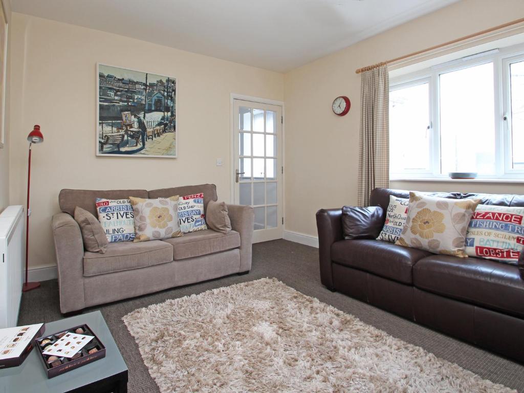 a living room with two couches and a rug at Chy-An-Mor in Carbis Bay