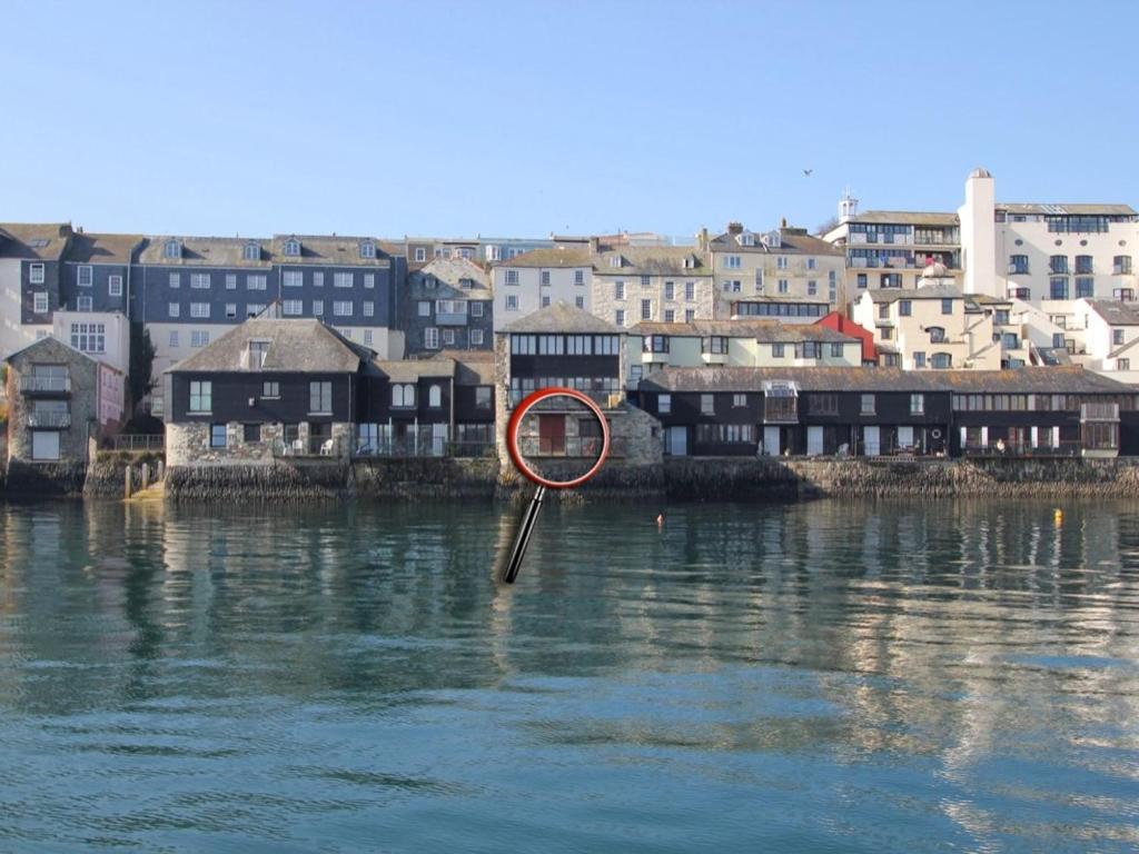 a sign in the water in front of a city at Tobys Quay in Falmouth