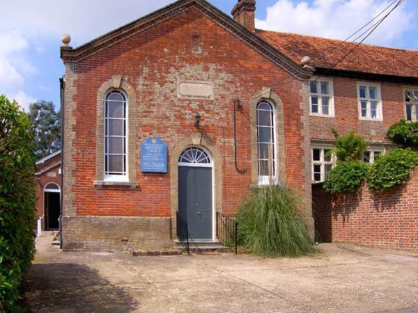 an old brick building with a blue door on it at The Methodist Chapel in Whiteparish