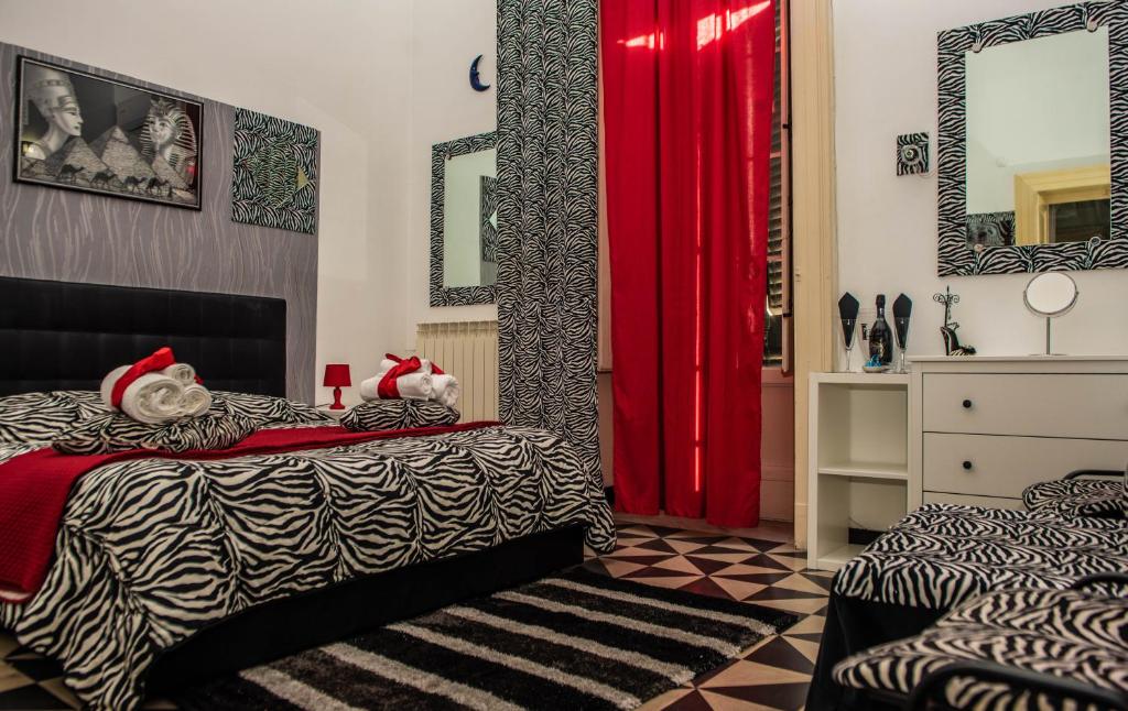 a bedroom with a bed with two stuffed animals on it at Pitagora House in Taranto