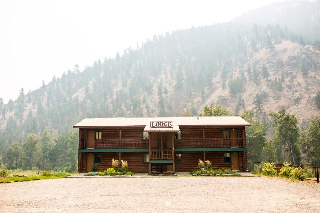 a building with a sign that reads lodge in front of a mountain at River's Fork Lodge in Salmon