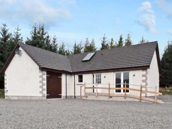 a white house with a black roof at Braewood in Invermoriston