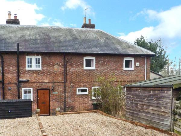 a red brick house with a large driveway at 3 Apsley Cottages in Chartham