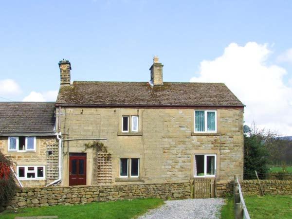 an old stone house with a stone driveway at Broadhay in Hathersage