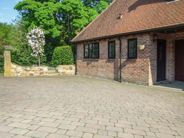 a brick building with a brick driveway in front of it at Beechcroft Corner House in Ecclesall