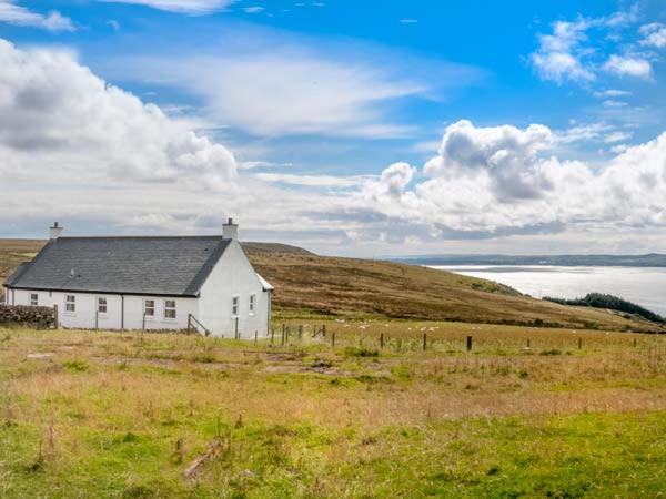 a white house in the middle of a field at Little Laight in Cairnryan