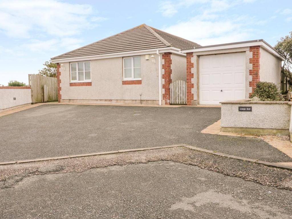 a house with a driveway in front of it at Llecyn Braf in Amlwch