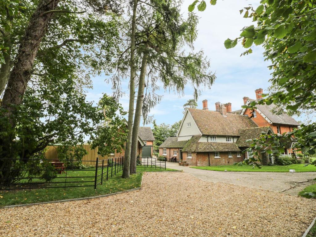 an image of a house with trees and a driveway at The Dower House in Yelden