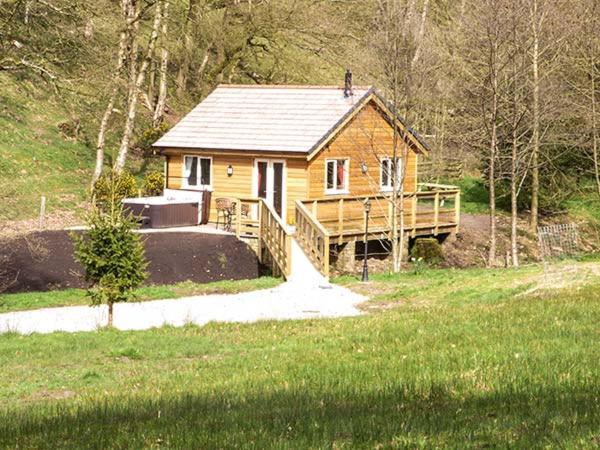 a small wooden house with a ramp leading to it at Park Brook Retreat in Scorton
