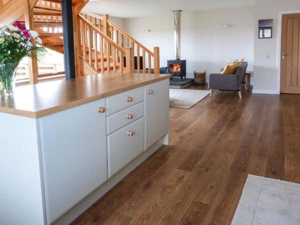 a kitchen with a counter top and a living room at Skipaflotta in Rhiconich