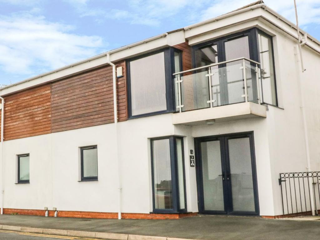 a house with large windows and a balcony at 3 Marina View in Pwllheli