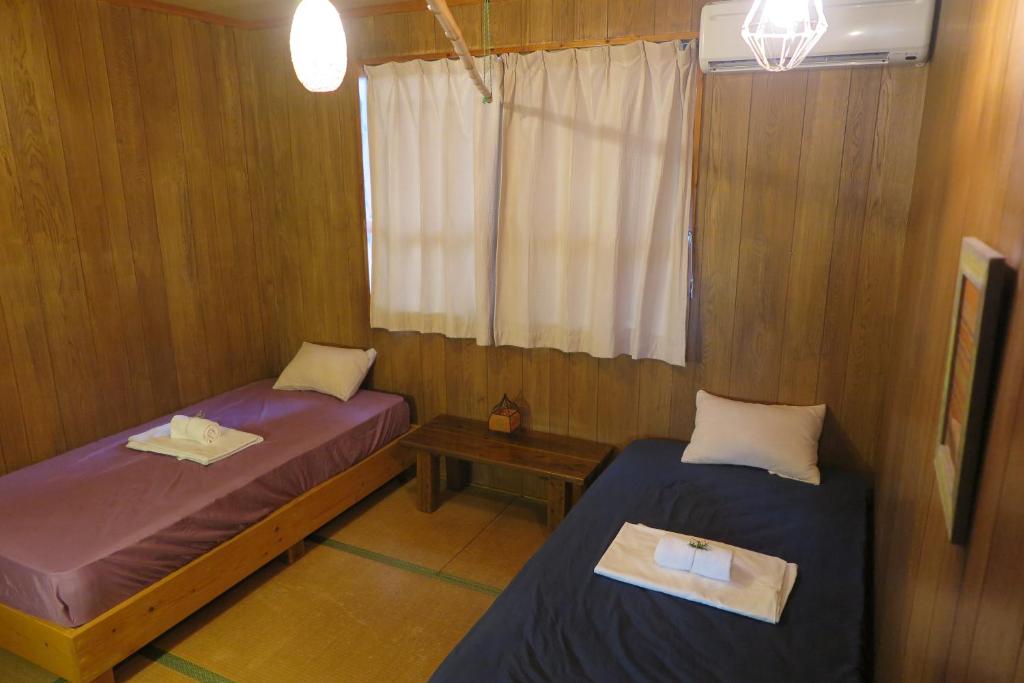 Postel nebo postele na pokoji v ubytování Hotel Hibiscus
