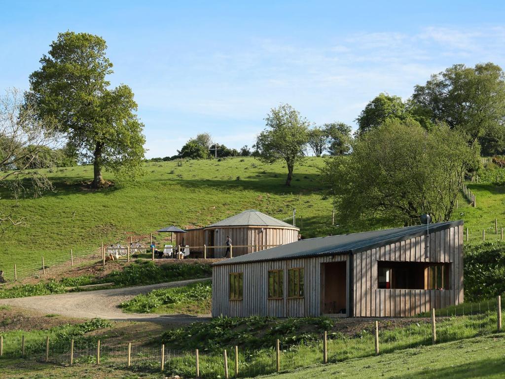 a couple of buildings in a field with trees at Rolling Hills in Newcastle