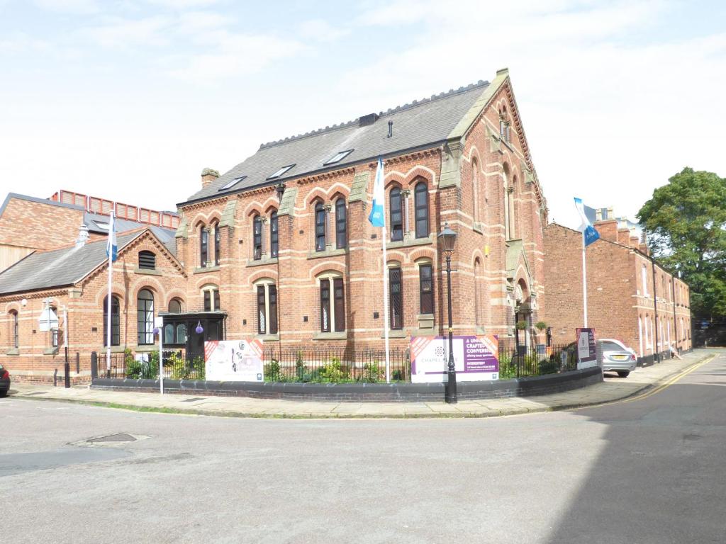 a large brick building on the corner of a street at 1 Chapel Place in Chester