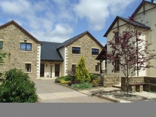 a large brick house with aphalt at Whitbarrow Holiday Village Troutbeck 5 in Penruddock