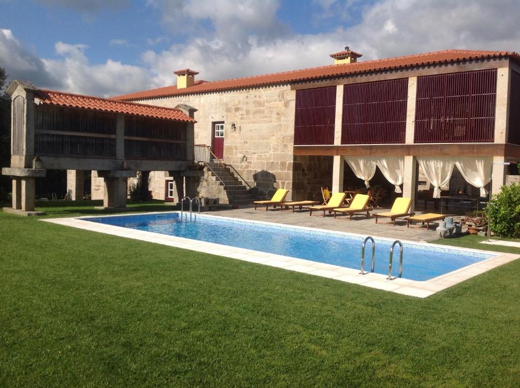 uma casa com piscina ao lado de um edifício em Casa da Ponte do Porto em Amares