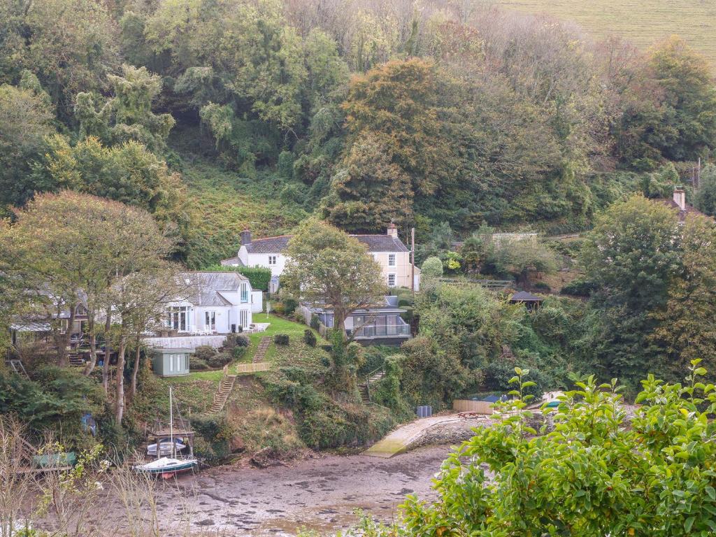 a group of houses on a hill next to a river at Junket Studio in Newton Ferrers