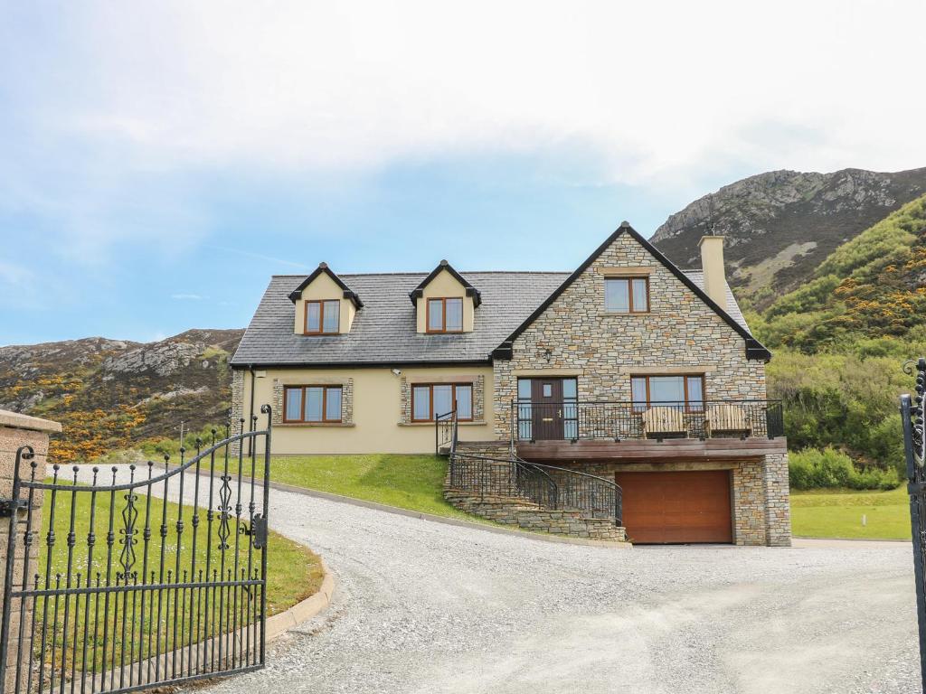 a large house with a gate and a driveway at Mulroy View in Burnfoot