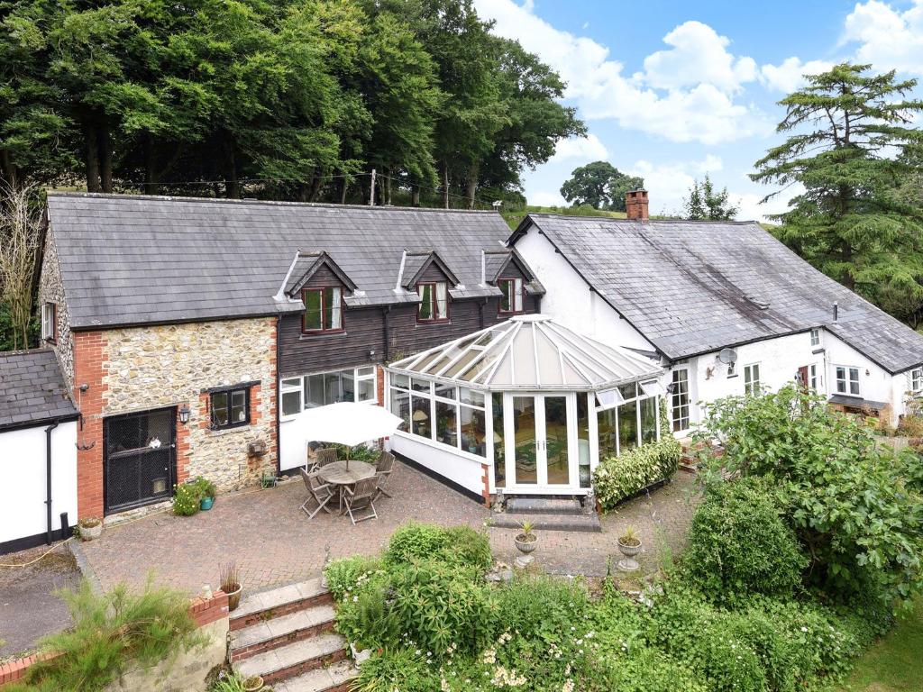 an external view of a house with a conservatory at Castle Hill Farm in Hemyock