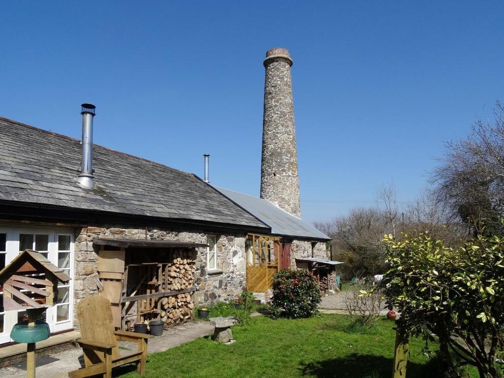 an old stone building with a smoke stack at The Old Engine House in Bodmin
