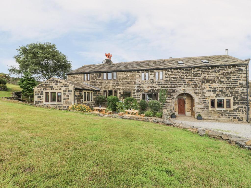 an old stone house with a large yard at The Long View in Hebden Bridge