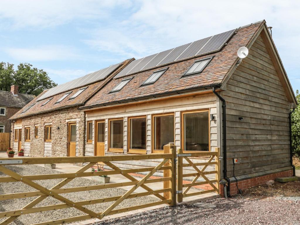 a barn conversion with solar panels on the roof at The Cow Byre, Heath Farm in Clee Saint Margaret