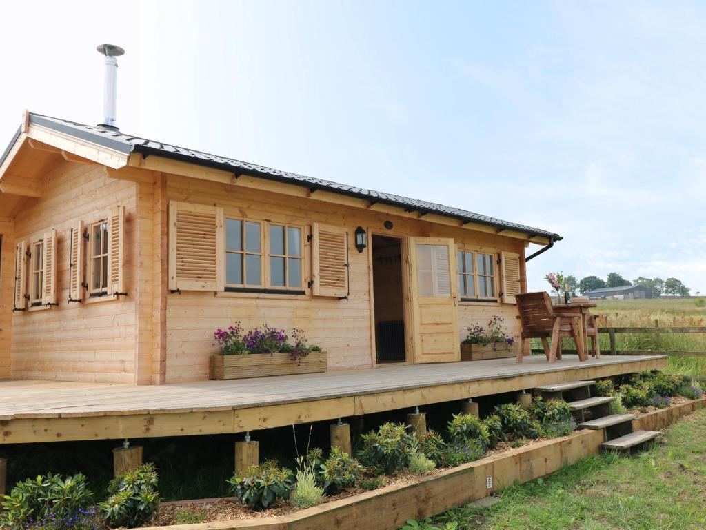a small wooden house on a wooden deck at The Shooting Lodge in Warslow