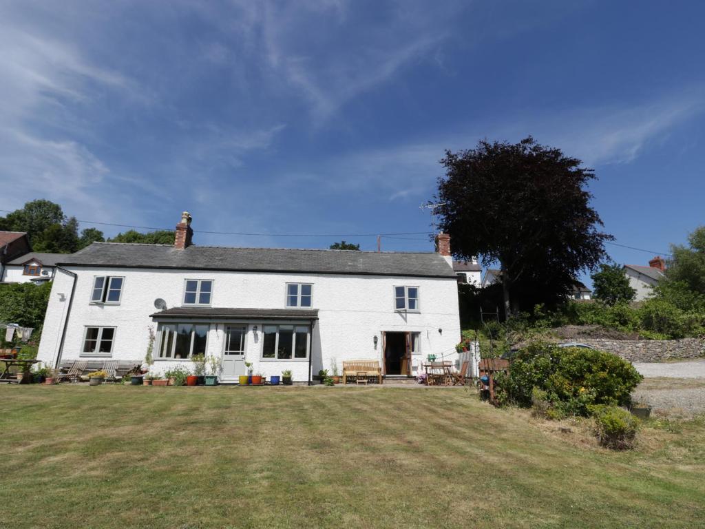 a large white house with a large yard at The Cottage in Llangollen