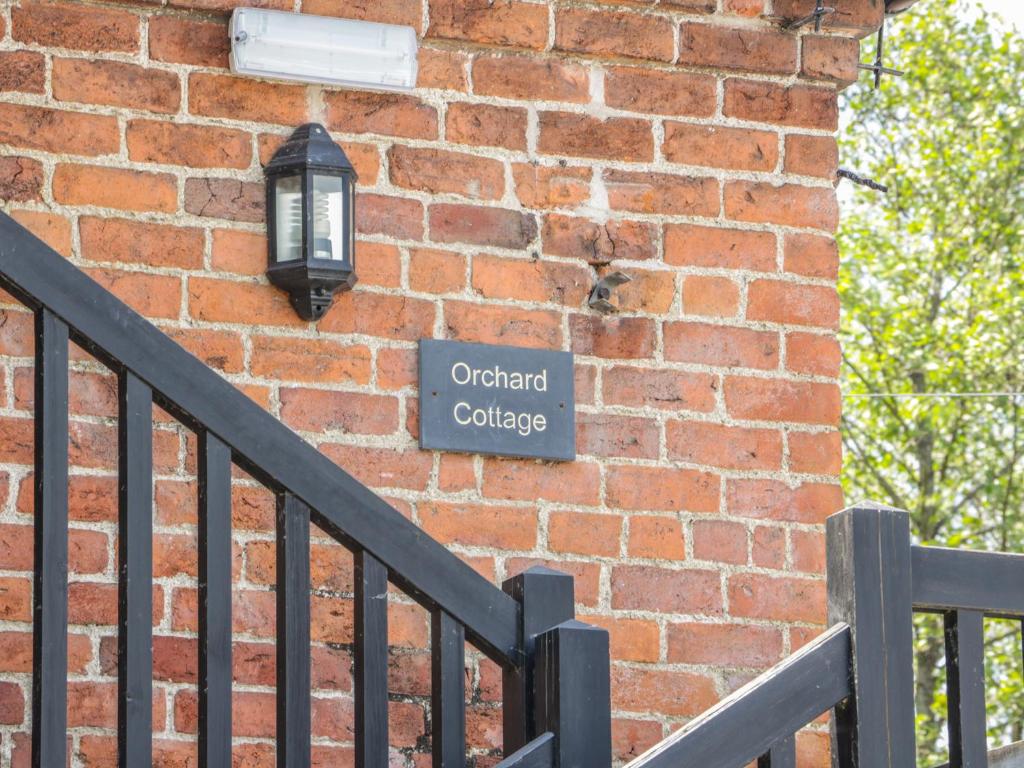 a brick wall with a street sign on it at Orchard Cottage in Kerry