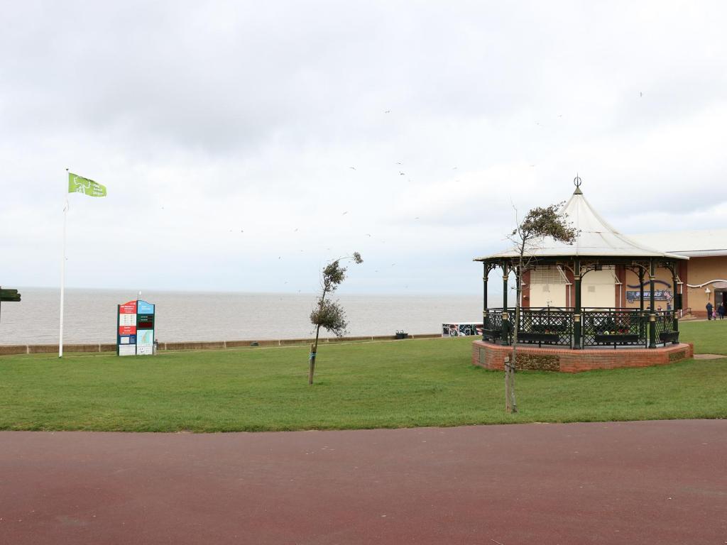 a gazebo in a park next to the ocean at Tilly's Retreat in Hunstanton