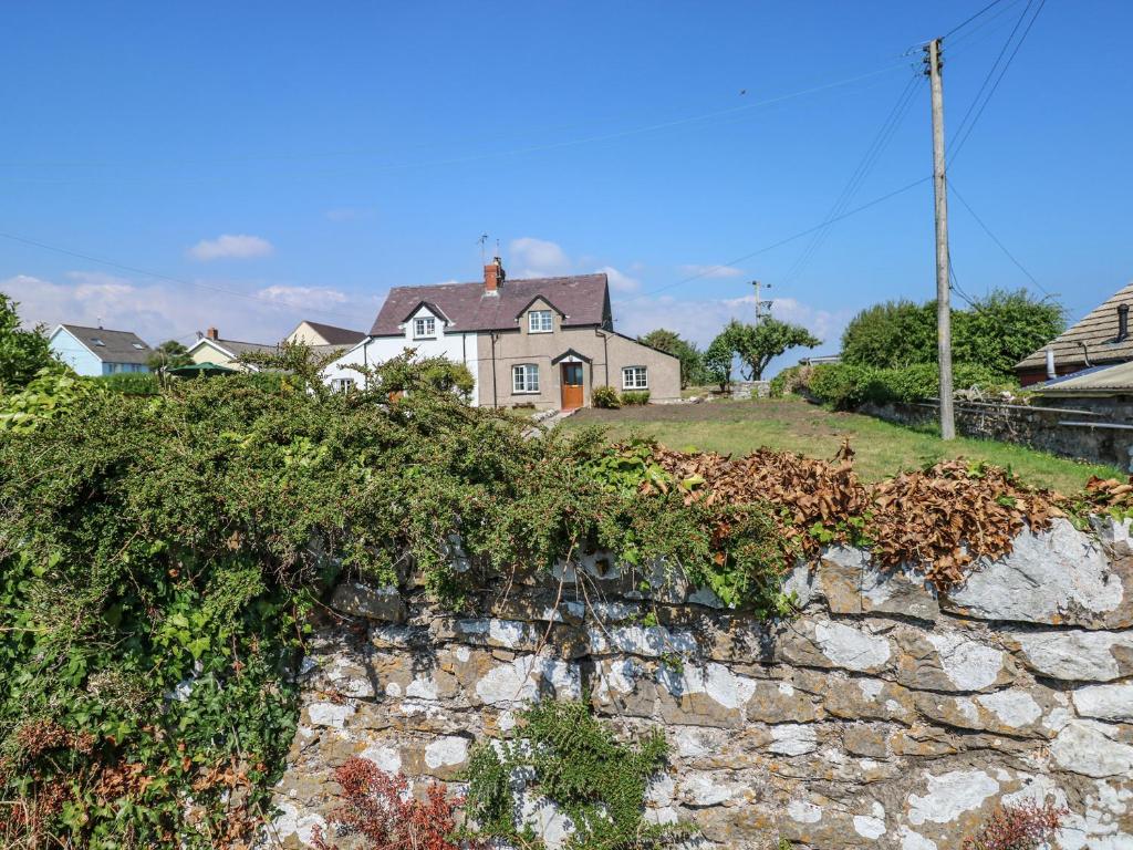 a house on top of a stone wall at No 2 New Cottages in Pembroke
