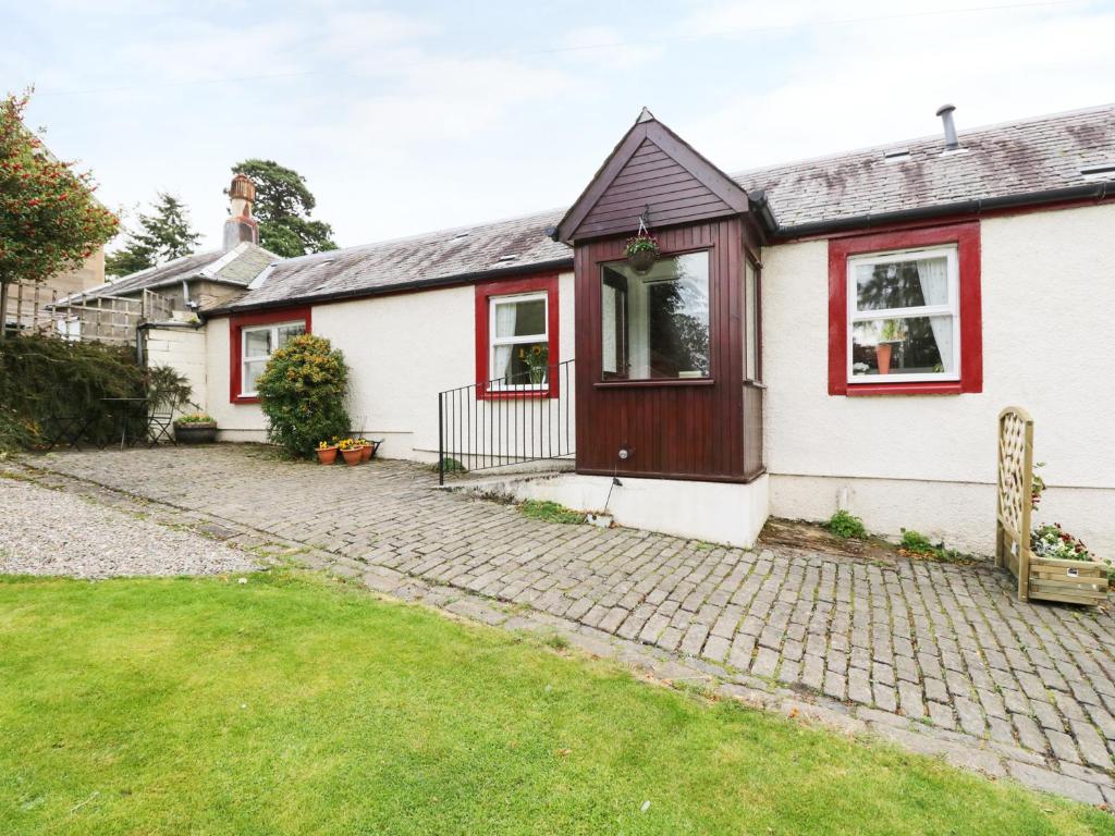 a white house with a red trim at Garden Cottage in Perth