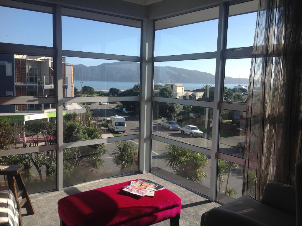 a room with a large window with a view of a city at Top Floor Bed and Breakfast in Paraparaumu Beach