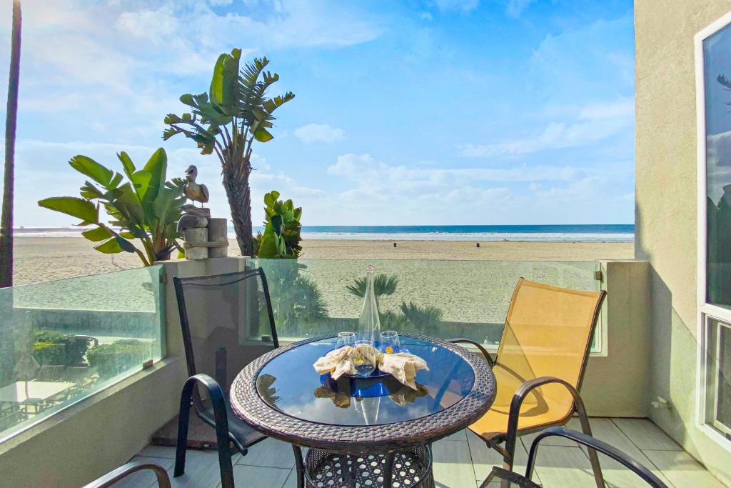 a table on a balcony with a view of the beach at Brighton Adventure in San Diego