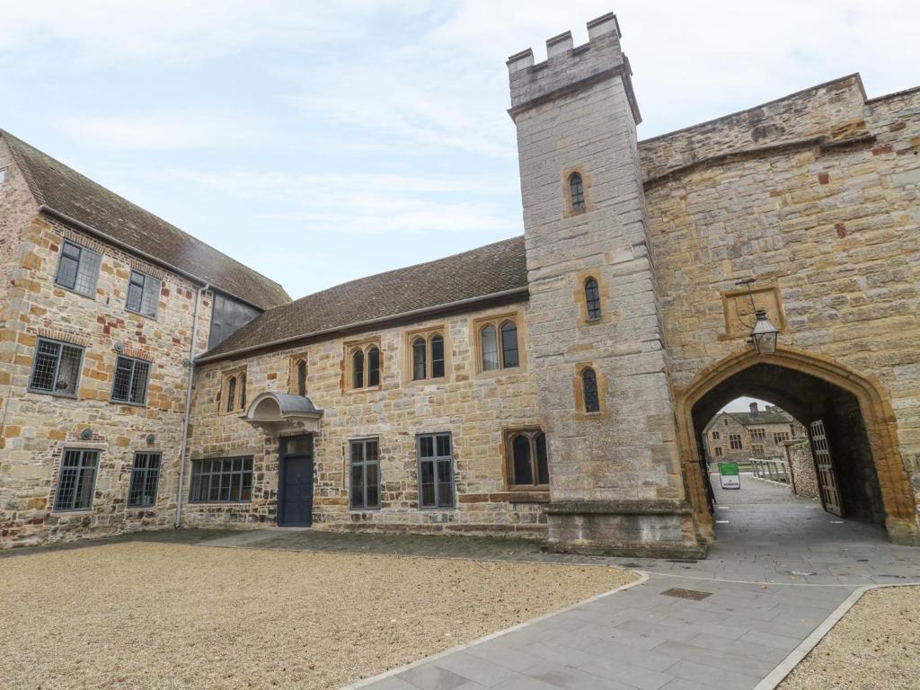 a large stone building with an archway at Castle House in Taunton