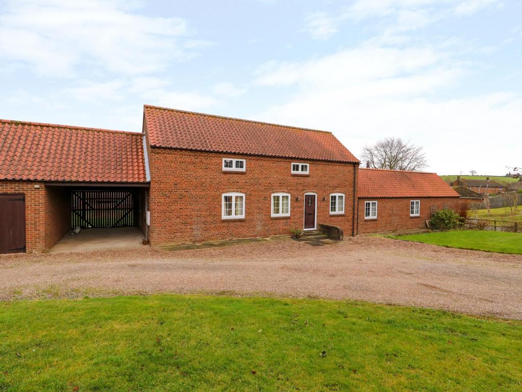 a large brick building with a large garage at Balmedie in Market Rasen