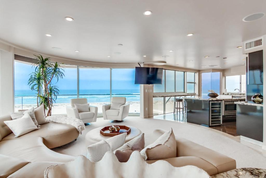 a living room with a white couch and a table at Ostend Getaway in San Diego