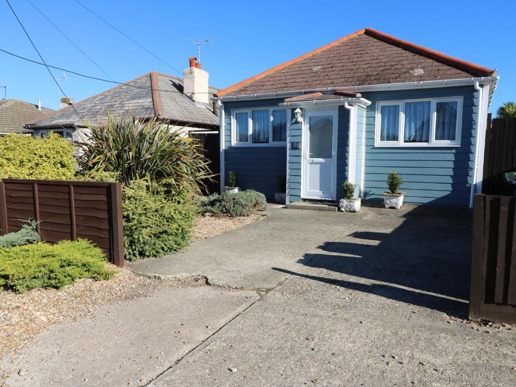 a blue house with a gate and a driveway at Smallcroft in Whitstable