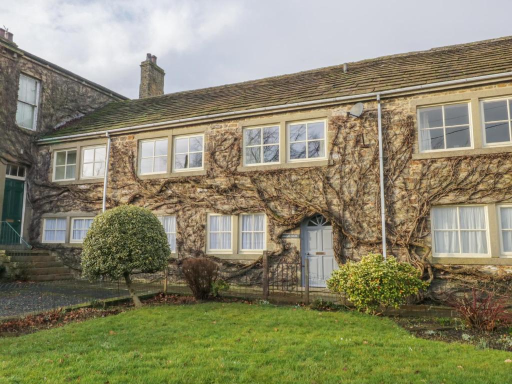 Casa de piedra antigua con ventanas blancas en Grange House en Skipton