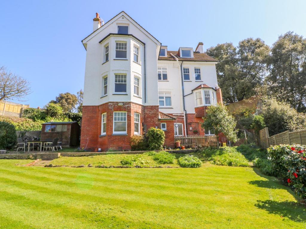 a large house with a lawn in front of it at 4 Greenhills in Folkestone