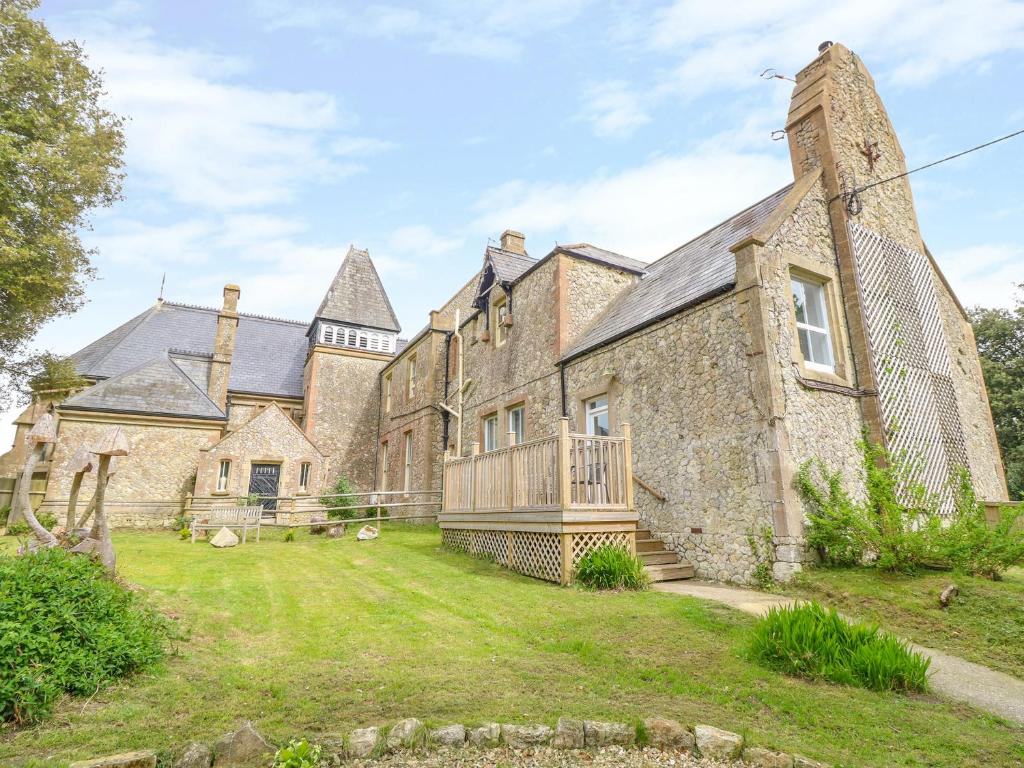 an exterior view of a large stone building at The Old Kitchens in Totland