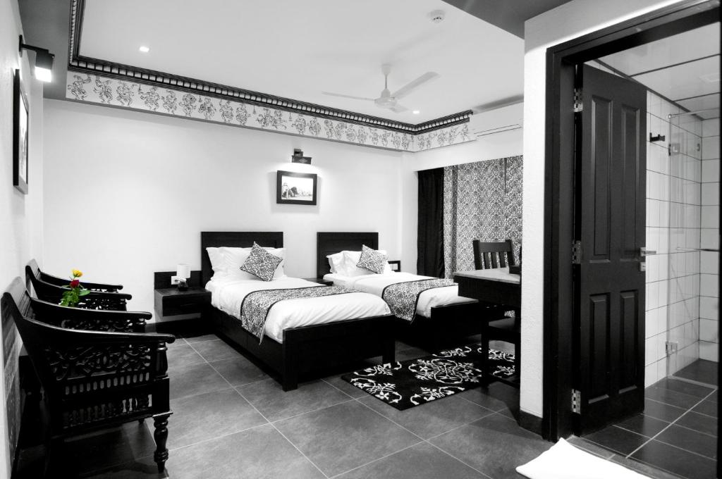 Postel nebo postele na pokoji v ubytování Liwa - The Transit Hotel, Bengaluru