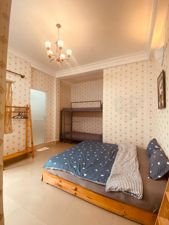 Postel nebo postele na pokoji v ubytování Da Lat Lemongrass - Đà Lạt Sả
