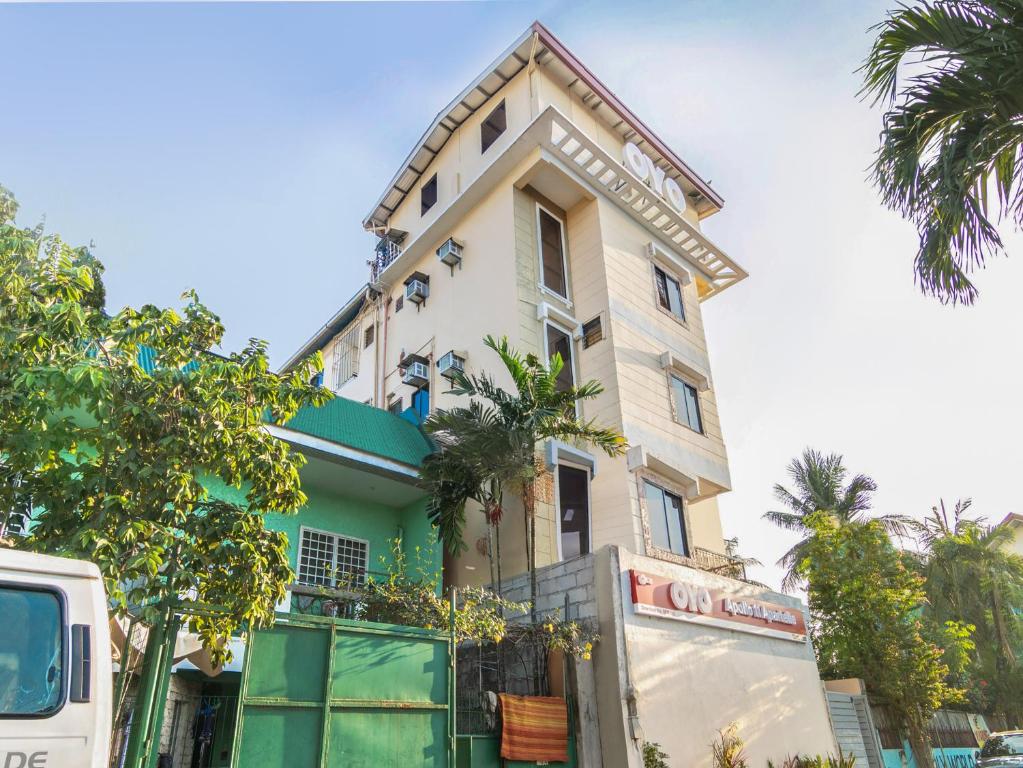 a house with a truck parked in front of it at OYO 431 Apollo 11 Apartelle in Manila