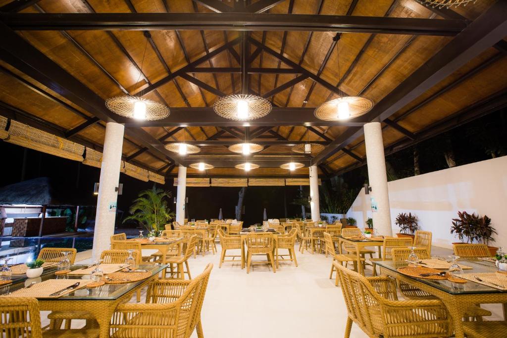 een grote eetkamer met tafels en stoelen bij Holiday Suites Port Barton in San Vicente