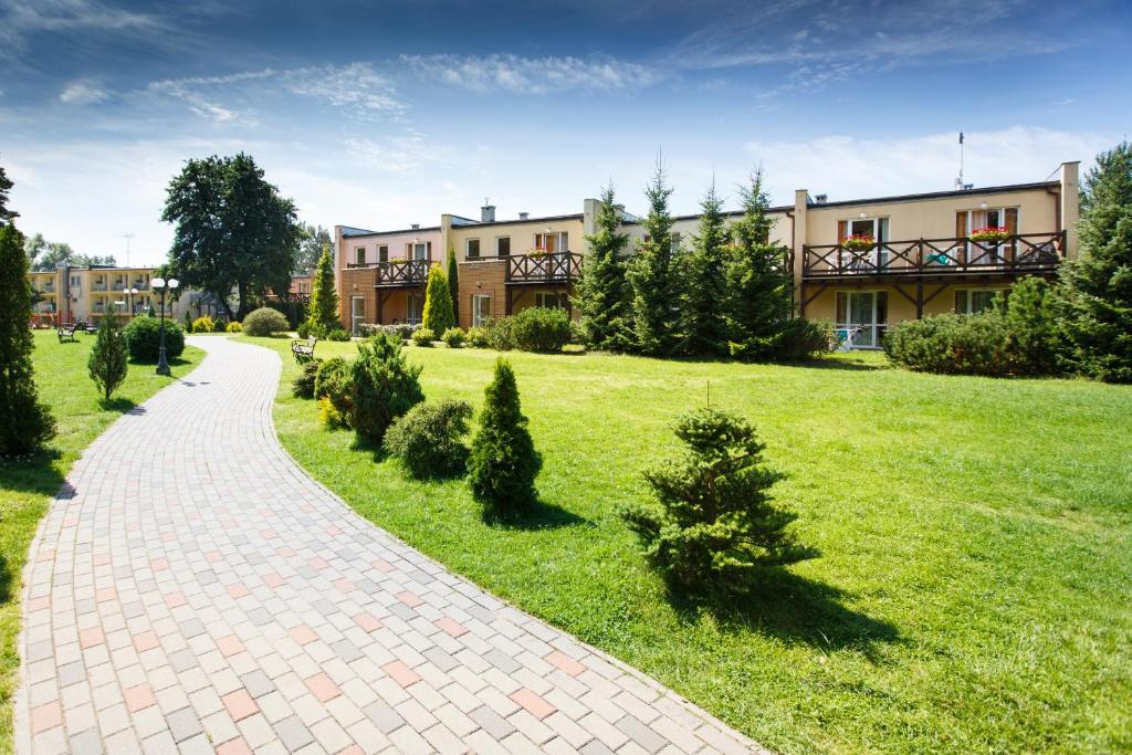 a brick path in front of a large building at OW Fala 1 in Łazy